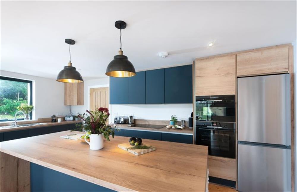 The kitchen island includes a built-in wine cooler at Beachside, Newquay